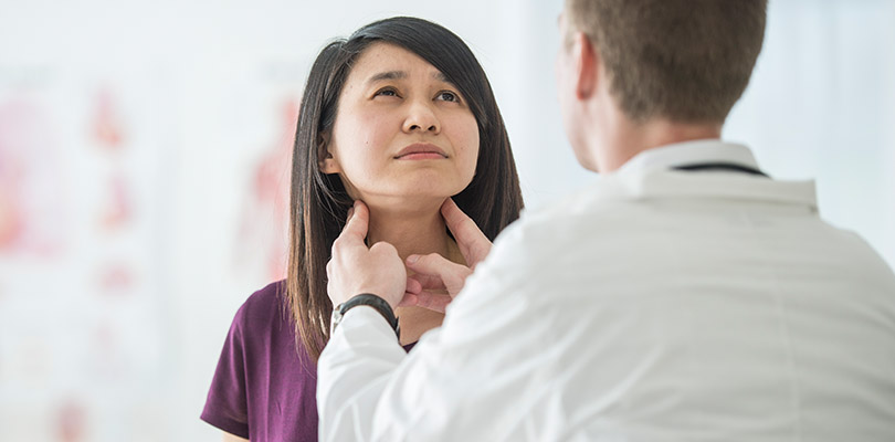 Female patient receives a thyroid examination for a cancer check